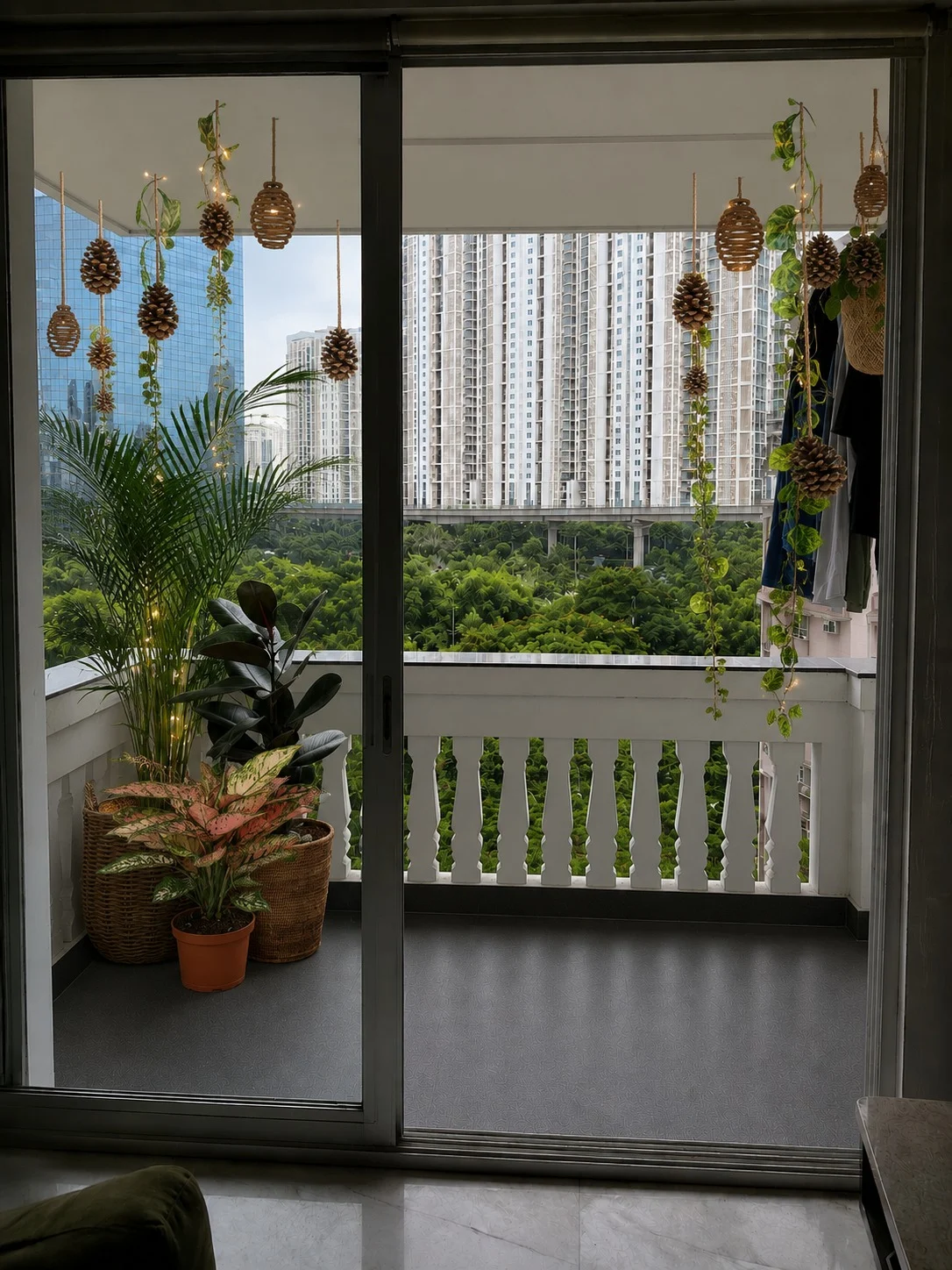 Balcony planting with woven hanging planters, palms and trailing foliage